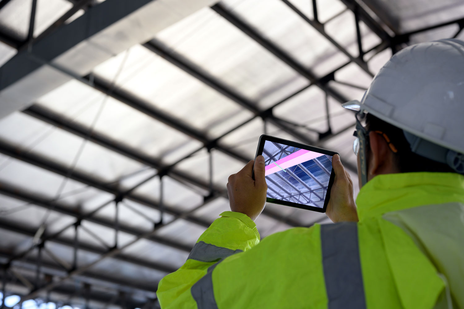 Mann auf Baustelle mit Tablet